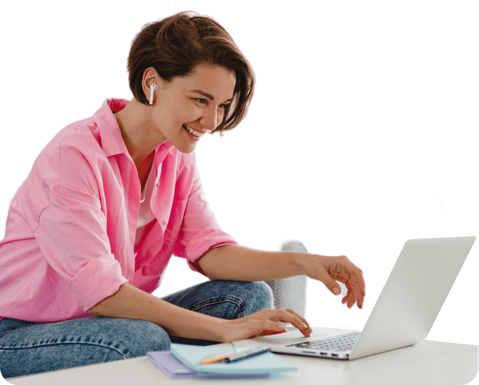 a woman sitting on the floor using a laptop computer.